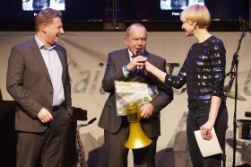 Andreas Lochbrunner nimmt stellvertretend die goldene Flüstertüte von SAP Mann Stefan Lacher entgegen. Die Moderatorin ist Susann Atwell.© Marco Grundt Andreas Lochbrunner